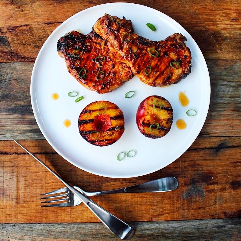 SmokeyQ Chipotle Rub pork chops with a honey bourbon glaze and grilled fruit - SmokeyQ